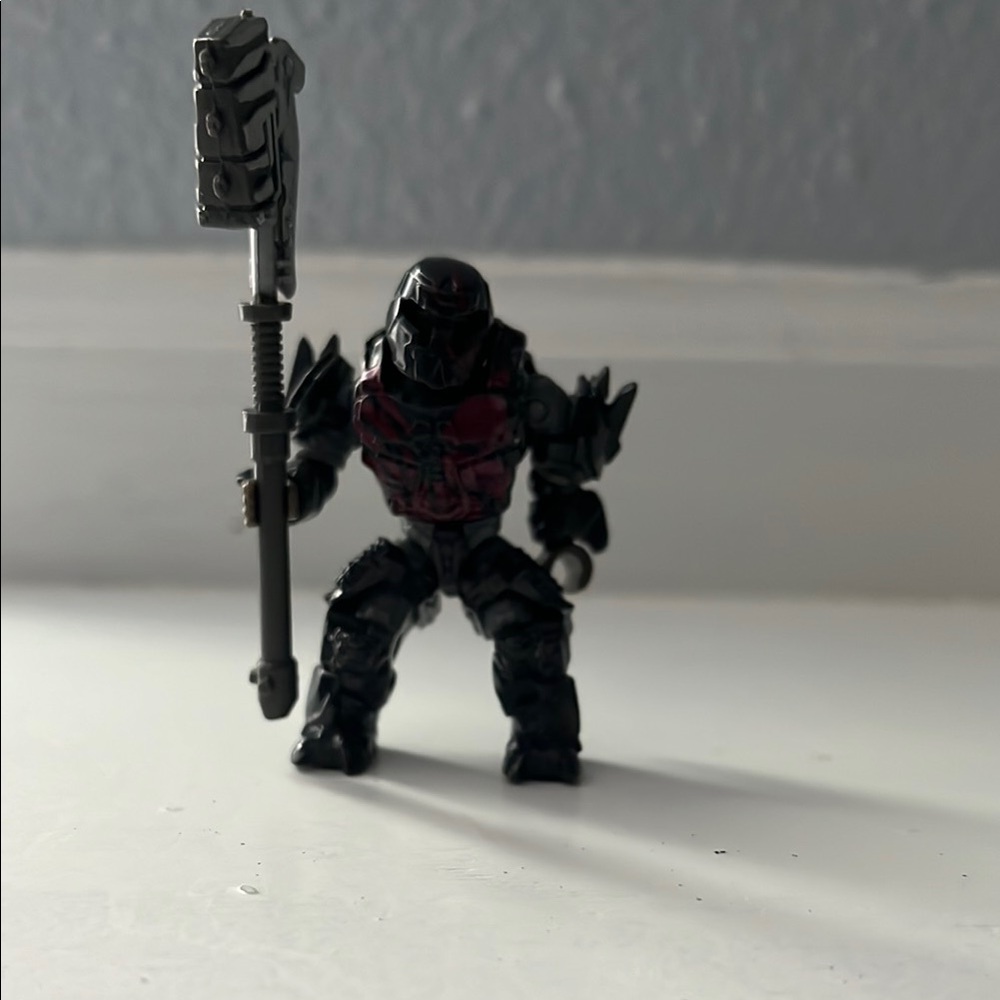 Black and Red Action Figure with Weapon